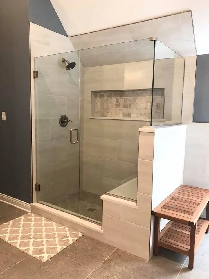 Glass walk-in shower with custom tile and vanity